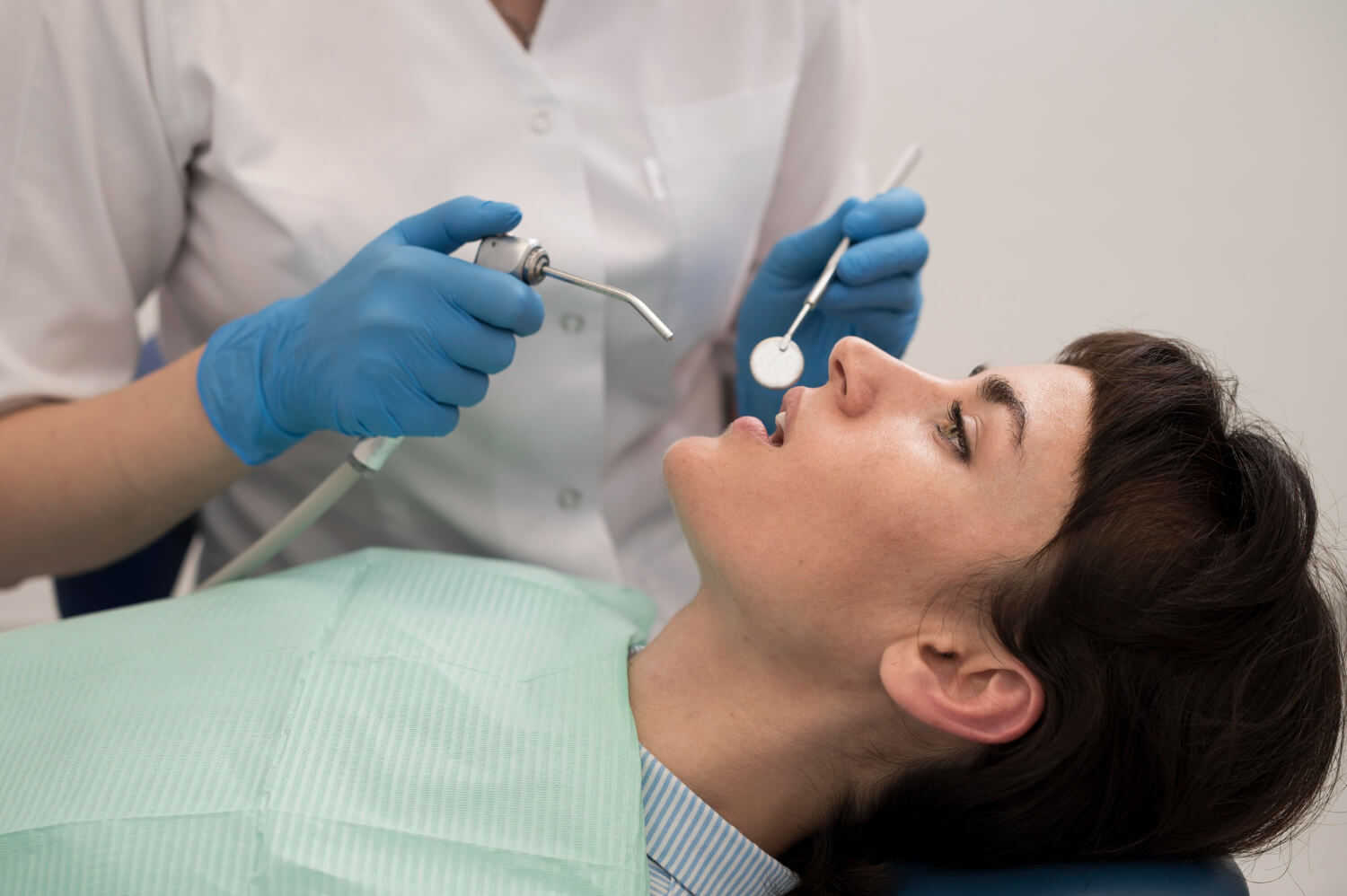 Paciente na cadeira odontológica recebendo atendimento para tratamento de canal na Clínica Perrella Odontologia em São Caetano do Sul.